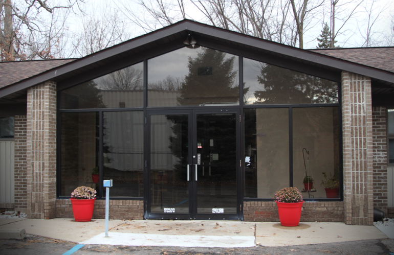 Building entrance with large glass doors.